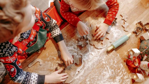 children making christmas cookies in christmas jumpers