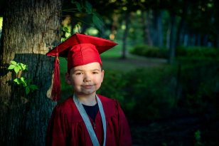 child wearing a graduation cap